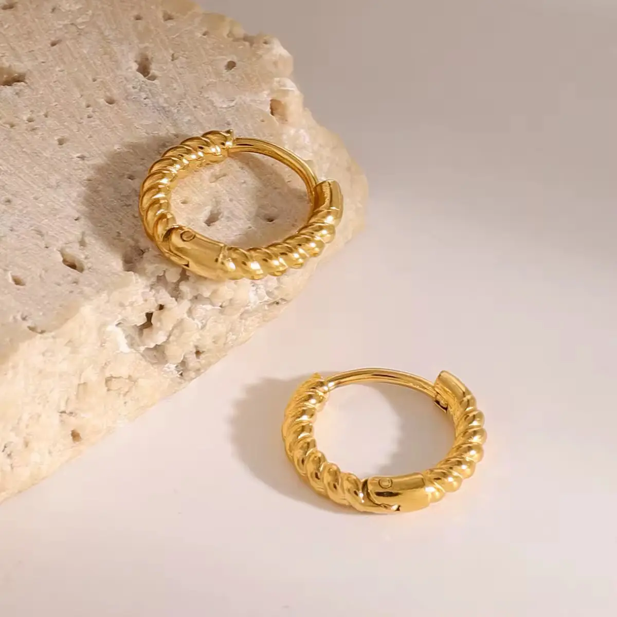 Golden Twist Hoop Earrings with elegant twisted gold-plated design – lightweight, hypoallergenic, and tarnish-resistant by Cleo Jewelry